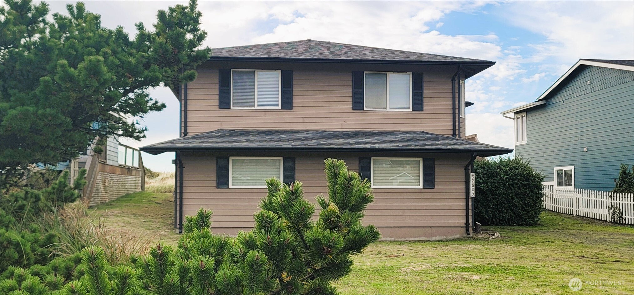 a front view of a house with a yard garage and outdoor seating