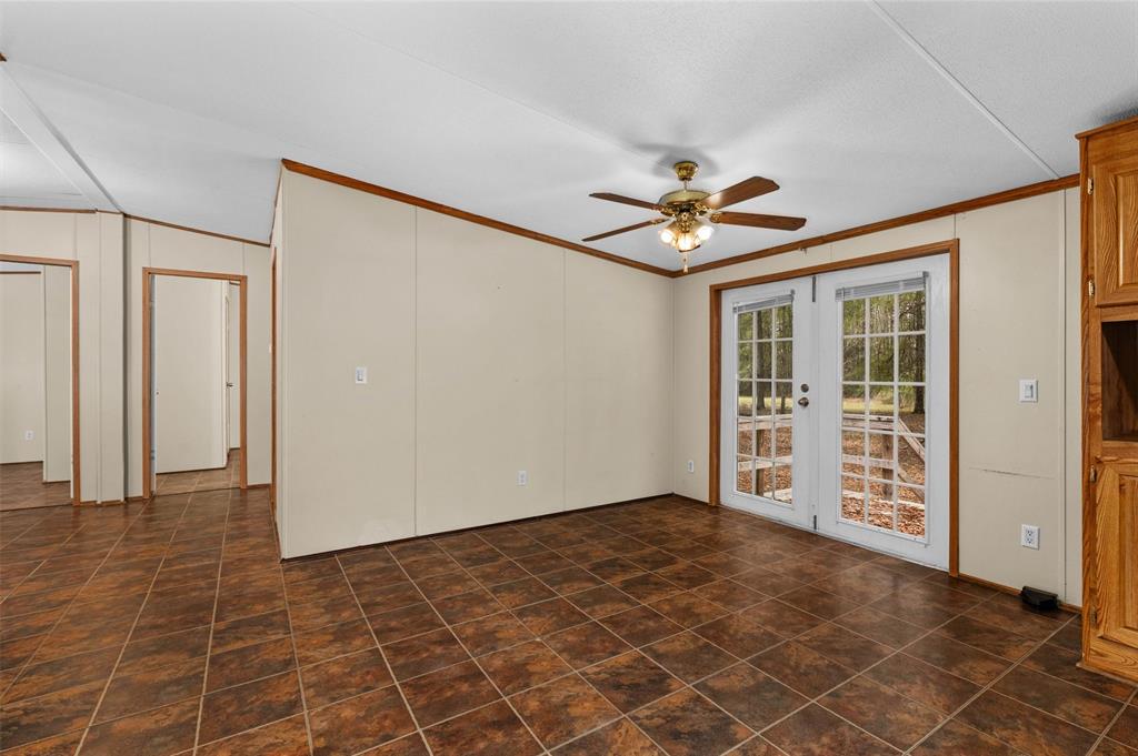 334 Destiny Lane Keatchie, LA 71046 - Photo 11 of 29 Empty room featuring ornamental molding, a ceiling fan, and french doors