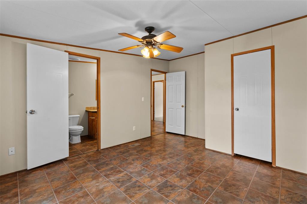 334 Destiny Lane Keatchie, LA 71046 - Photo 18 of 29 Unfurnished bedroom with crown molding, ceiling fan, and connected bathroom