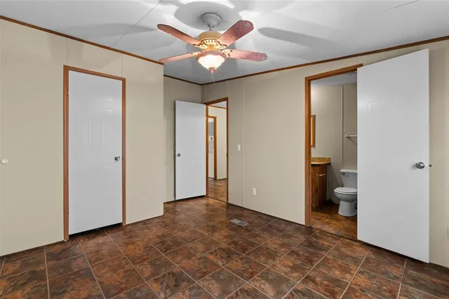 wooden floor in an empty room and a bathroom