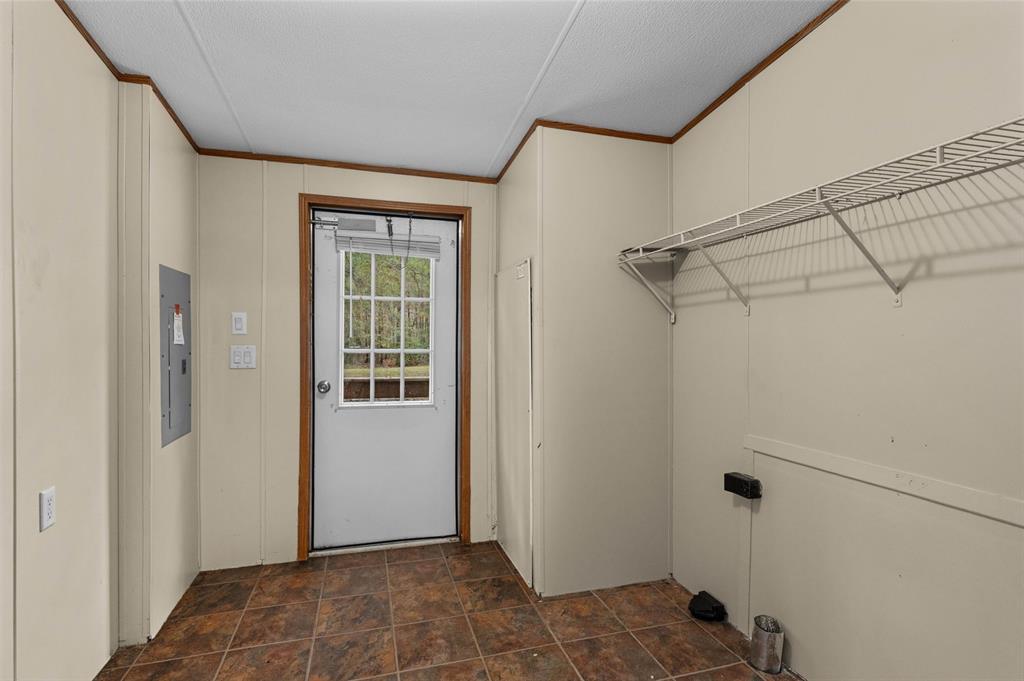 334 Destiny Lane Keatchie, LA 71046 - Photo 24 of 29 Washroom with stone finish floors, electric panel, and ornamental molding