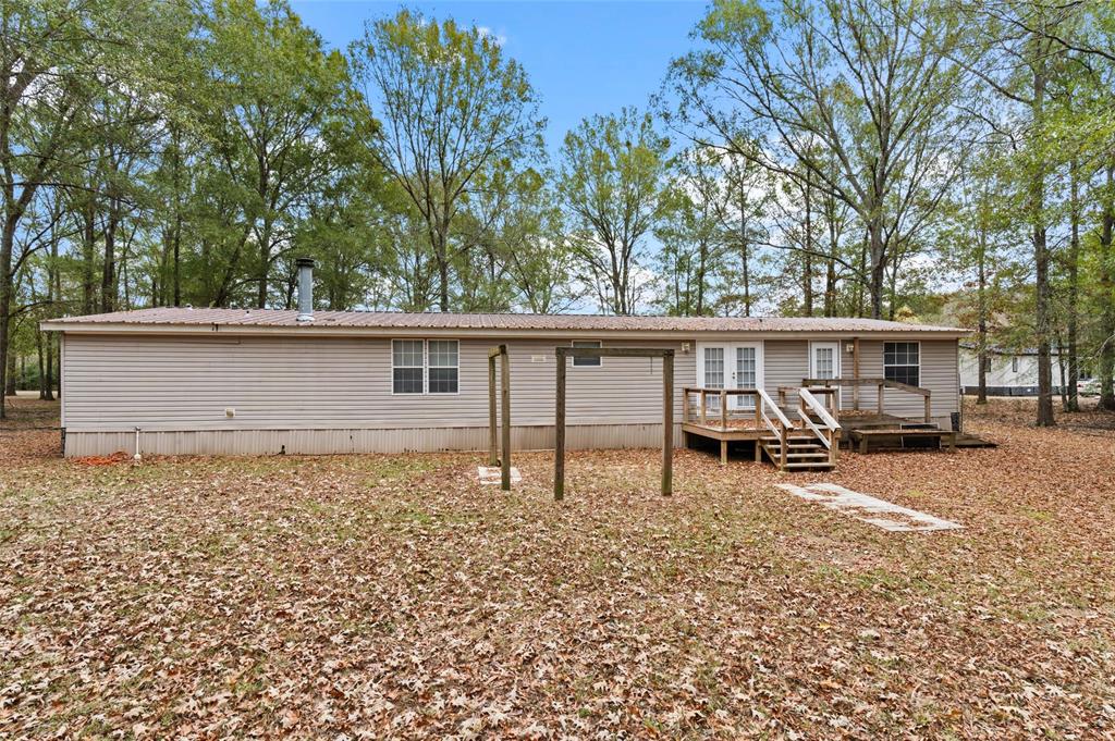 334 Destiny Lane Keatchie, LA 71046 - Photo 25 of 29 Rear view of property with a wooden deck