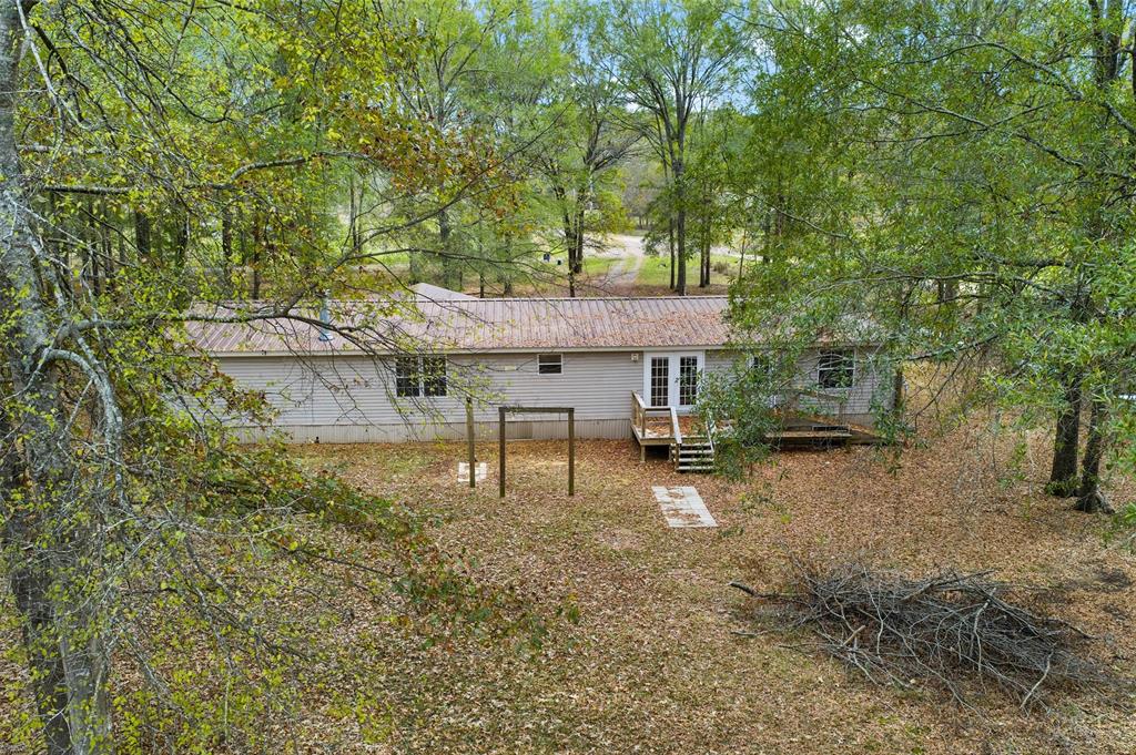 334 Destiny Lane Keatchie, LA 71046 - Photo 26 of 29 Rear view of property with a deck and a metal roof