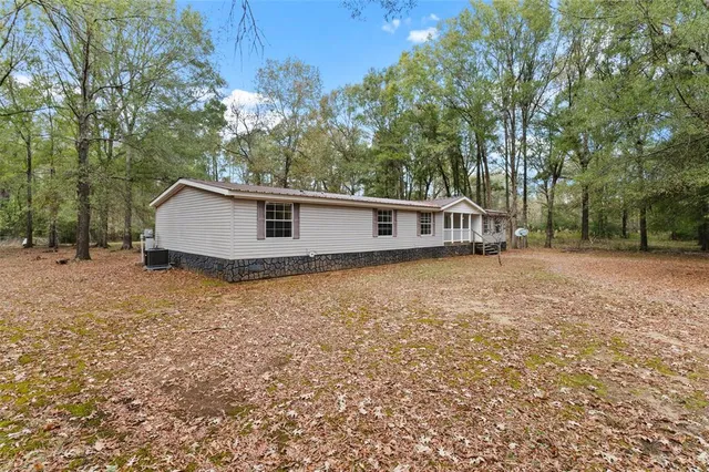 a view of a house with a backyard