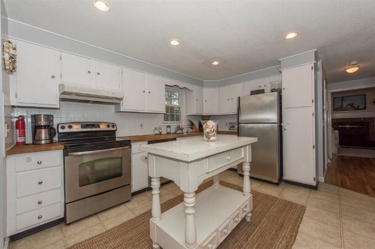 17 Crowell Road Sandwich, MA 02563 - Photo 3 of 25 a kitchen with a stove a sink and a refrigerator