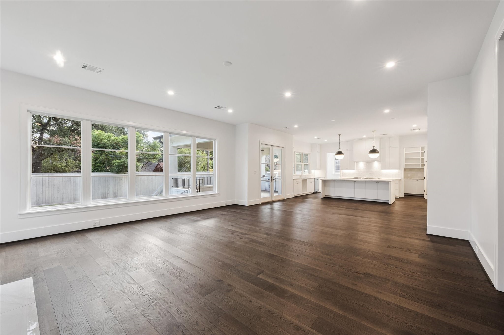 3011 Deal Street Houston, TX 77025 - Photo 14 of 45 a view of empty room with wooden floor and windows