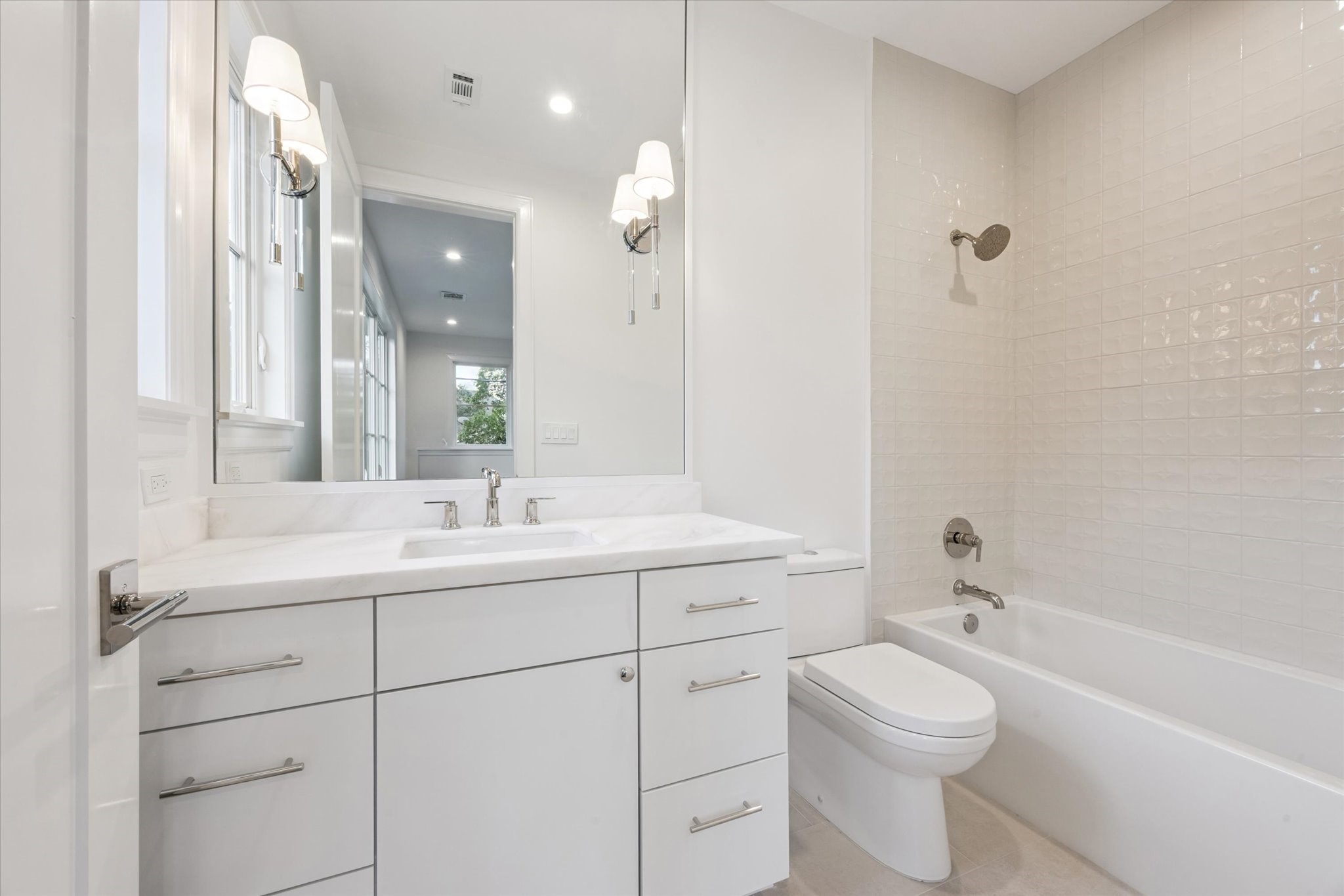 3011 Deal Street Houston, TX 77025 - Photo 34 of 45 a bathroom with a toilet a sink a mirror a bathtub and vanity