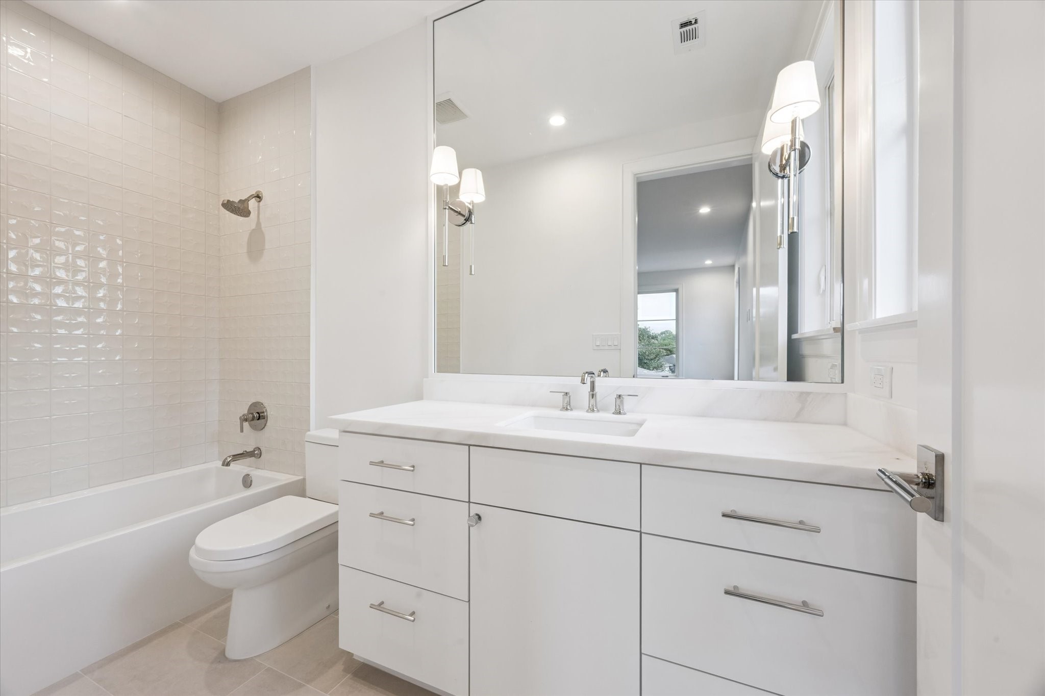 3011 Deal Street Houston, TX 77025 - Photo 35 of 45 a bathroom with a toilet a sink a mirror and a bathtub