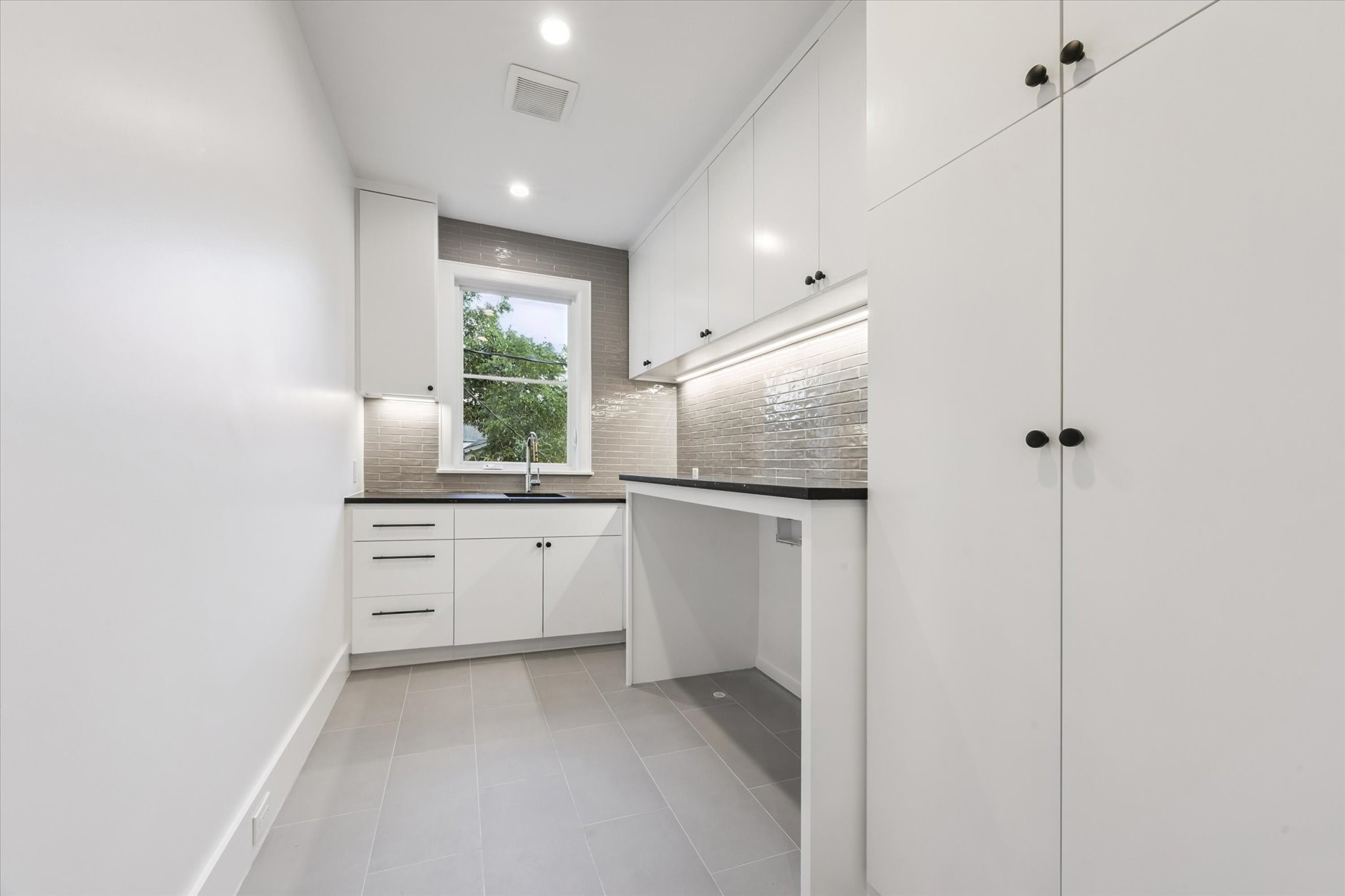 3011 Deal Street Houston, TX 77025 - Photo 45 of 45 a kitchen with white cabinets and window