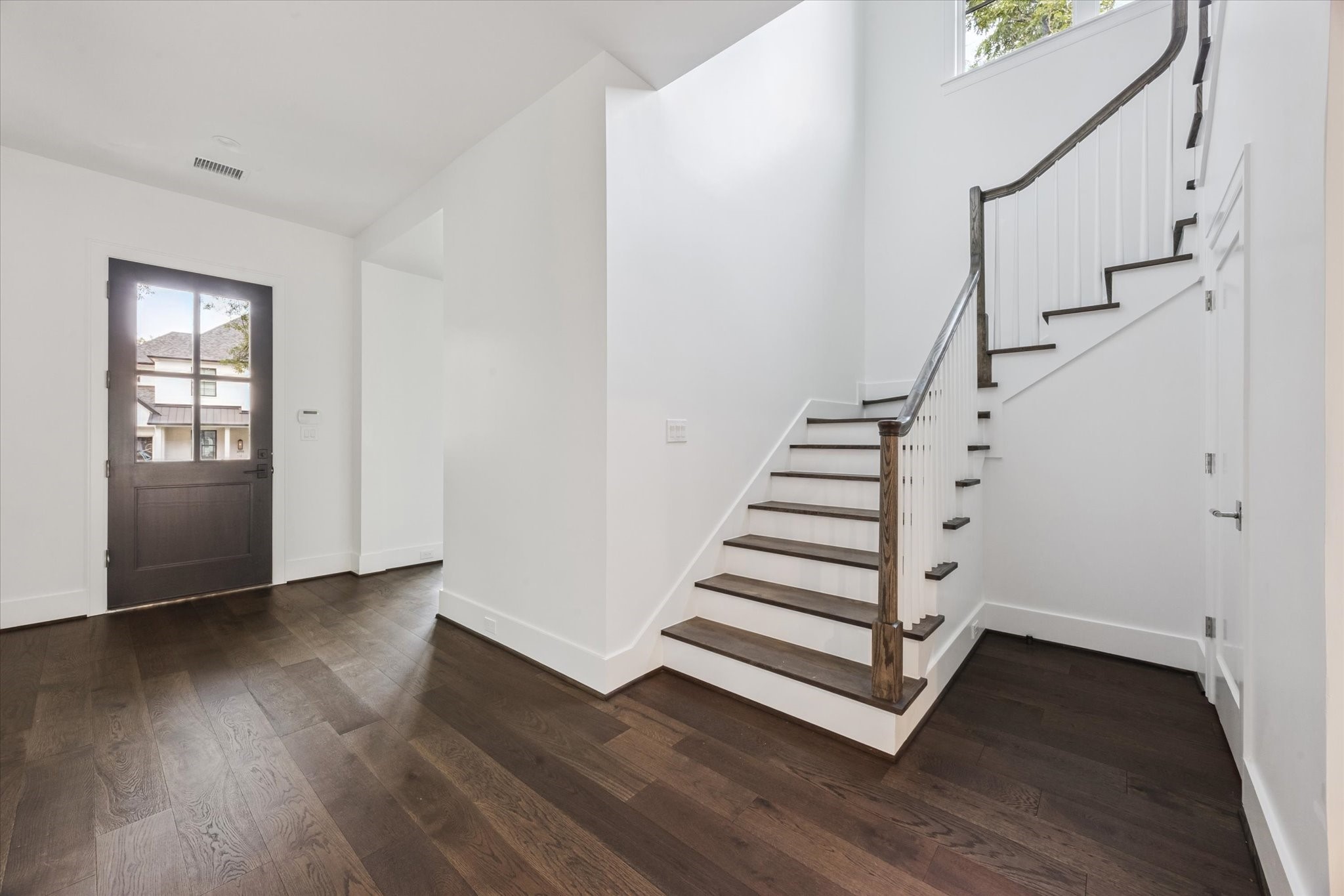 3011 Deal Street Houston, TX 77025 - Photo 8 of 45 a view of entryway with wooden floor and stairs