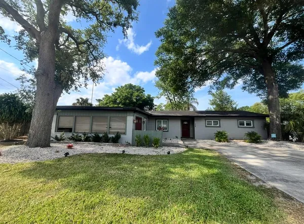 a backyard of a house with table and chairs