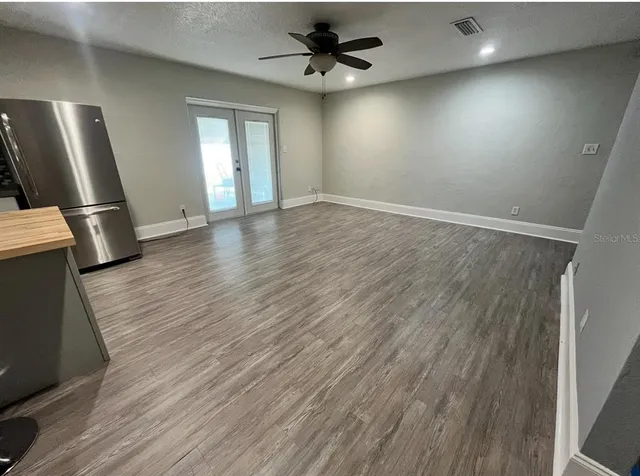 wooden floor in an empty room with a window