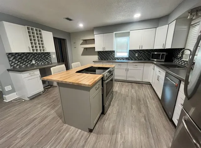 a kitchen with a sink stove and refrigerator