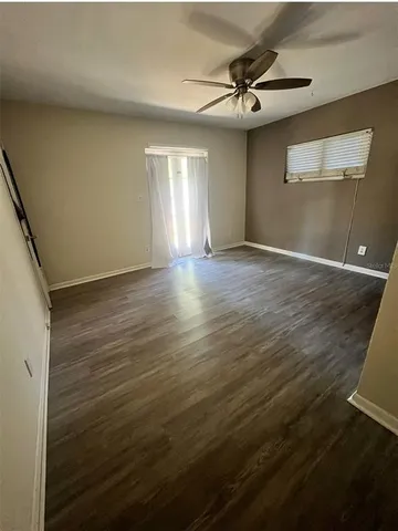 a view of a livingroom with a ceiling fan and window