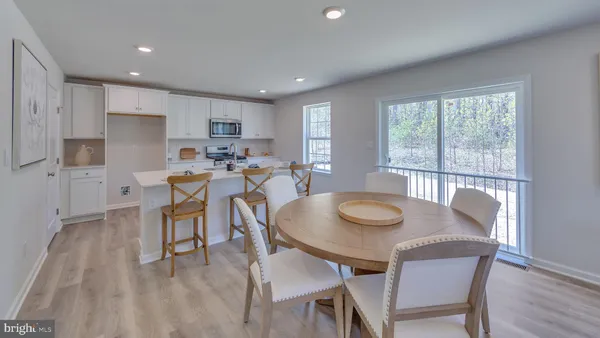 a dining room with furniture and wooden floor