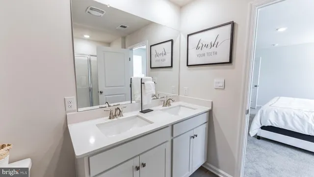 a en suite bathroom with a sink and a mirror
