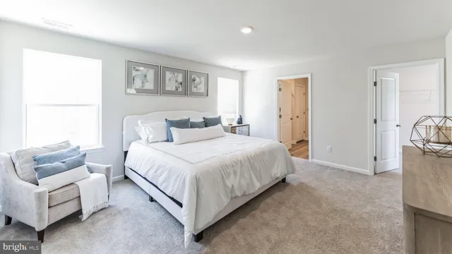 a spacious bedroom with a bed and a couch