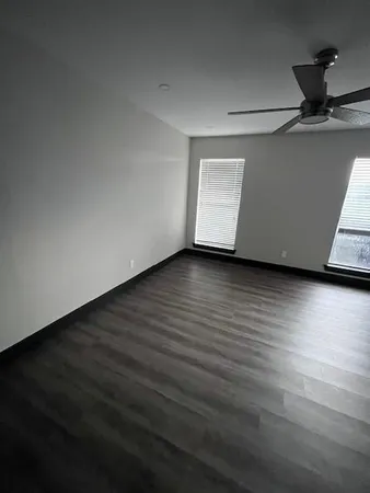 a view of an empty room and wooden floor