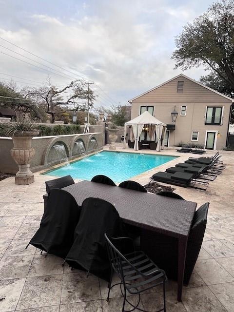 7734 Meadow Road, Unit 117 Dallas, TX 75230 - Photo 15 of 15 a view of a roof deck with table and chairs under an umbrella