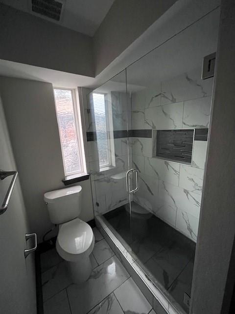 7734 Meadow Road, Unit 117 Dallas, TX 75230 - Photo 9 of 15 a bathroom with a toilet a sink and a window