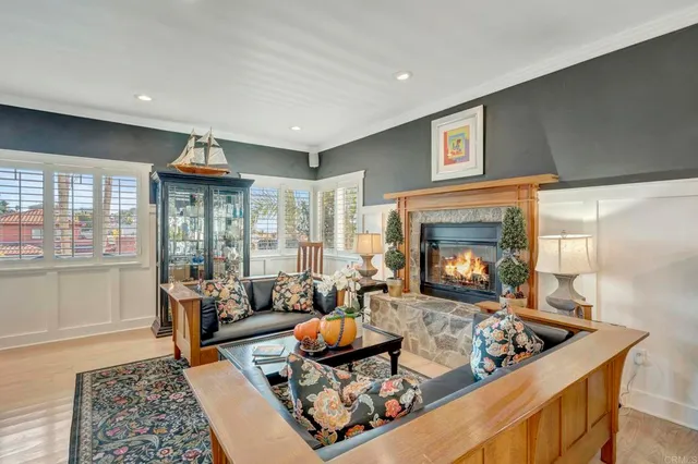 a living room with furniture a dining table and a large window