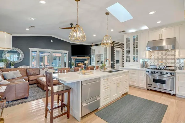a living room with furniture and a dining table with kitchen view