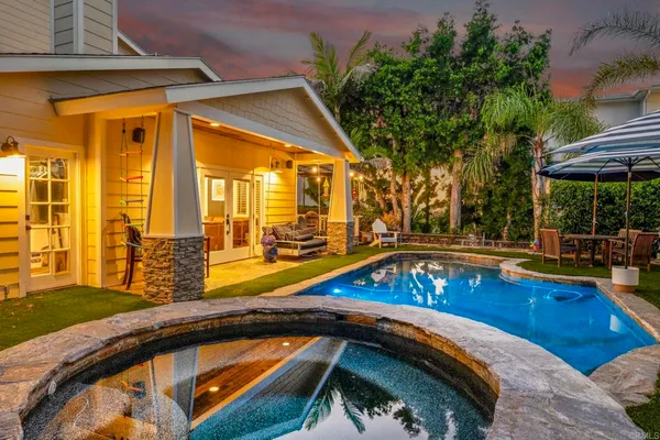 a view of swimming pool with chairs and table under an umbrella