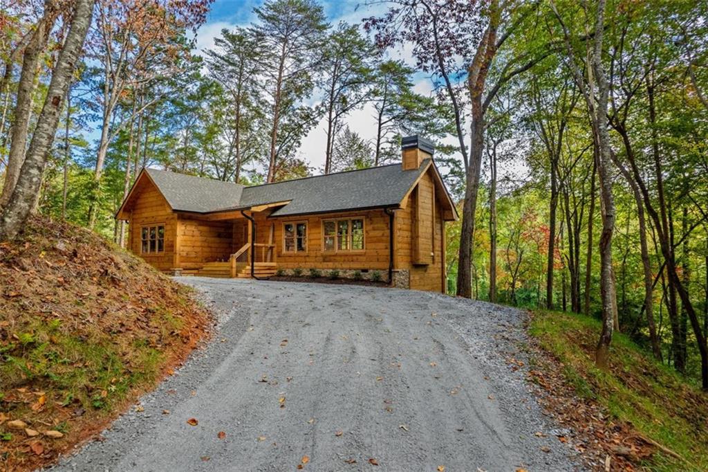 85 Moreland Trail Blue Ridge, GA 30513 - Photo 13 of 37 a front view of a house with a yard and garage