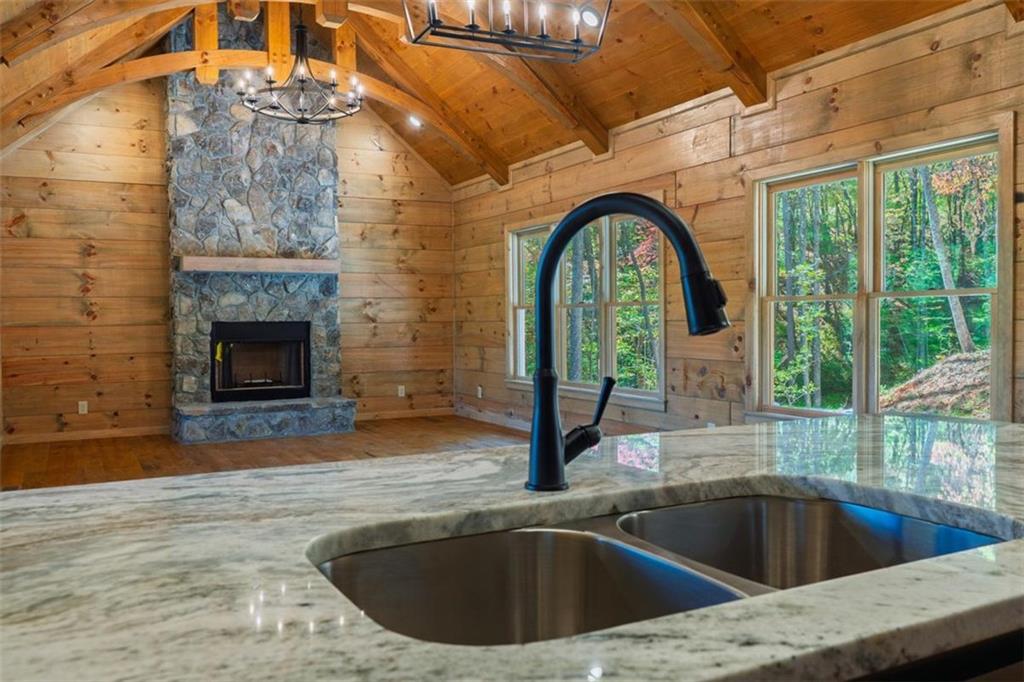 85 Moreland Trail Blue Ridge, GA 30513 - Photo 23 of 37 a view of a kitchen with a sink and dishwasher with a fireplace