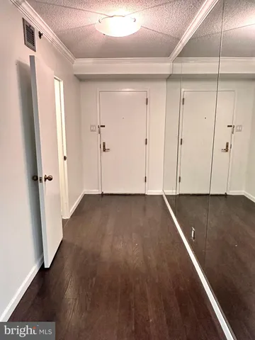 a view of a room with wooden floor