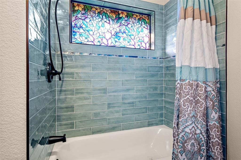 400 Hunters Ridge Circle Coppell, TX 75019 - Photo 24 of 35 a bathroom with a bathtub and shower