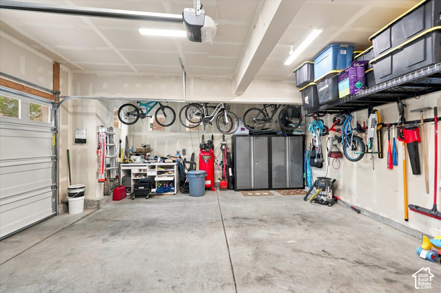 972 Vine Street Mapleton, UT 84664 - Photo 35 of 40 Spacious garage featuring a concrete floor, overhead storage racks, and wall-mounted organization systems