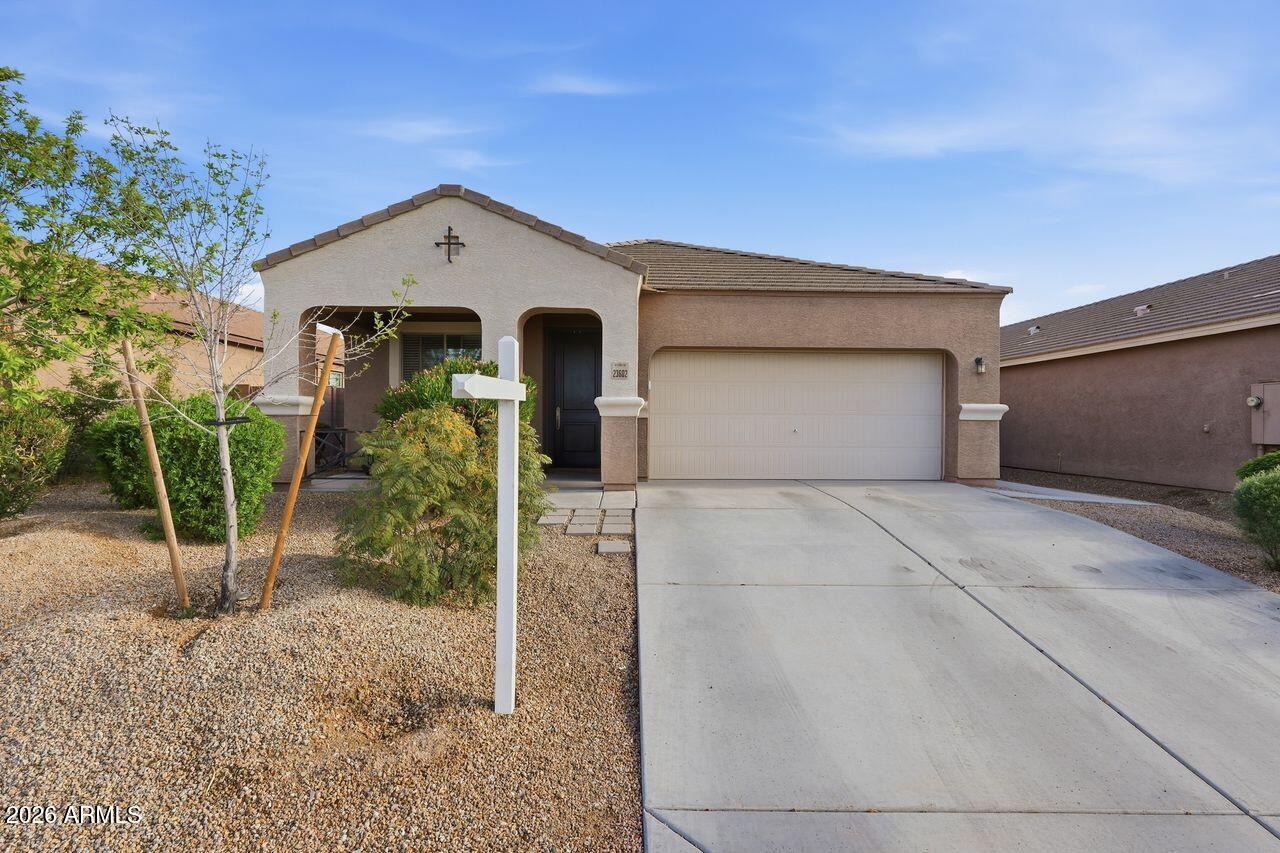 23602 West Ripple Road Buckeye, AZ 85326 - Photo 1 of 38 a front view of a house with garden