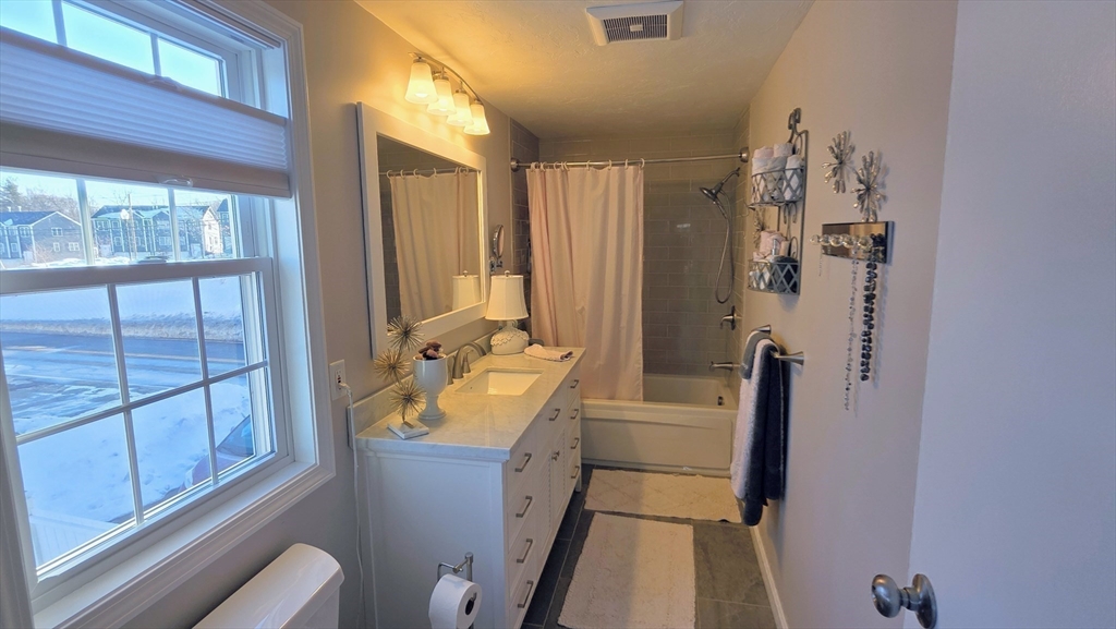 533 Prospect Street West Boylston, MA 01583 - Photo 18 of 40 a bathroom with a sink a mirror and a bathtub