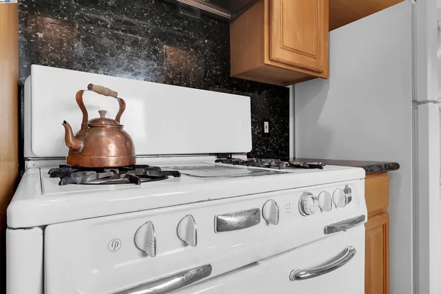 a stove top oven sitting inside of a kitchen