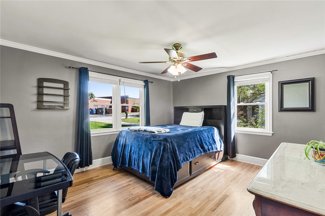 512 East Fredericks Street Anderson, SC 29621 - Photo 17 of 31 Hardwood floors and a ceiling fan enhance this naturally illuminated bedroom.