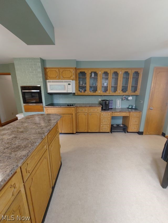 2211 Devonshire Road Northwest Canton, OH 44708 - Photo 9 of 36 Kitchen with a fireplace, light carpet, and brick wall