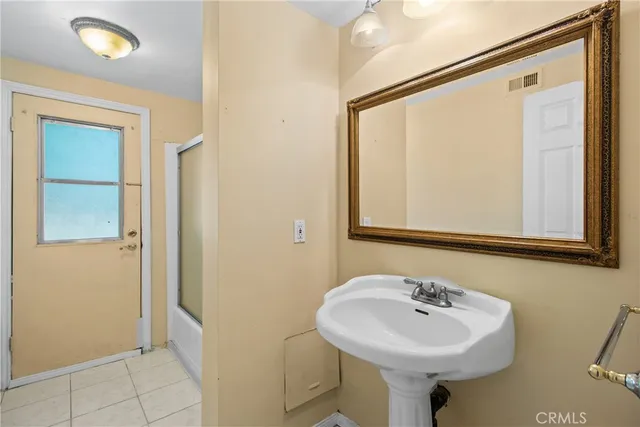 a bathroom with a sink a mirror and shower