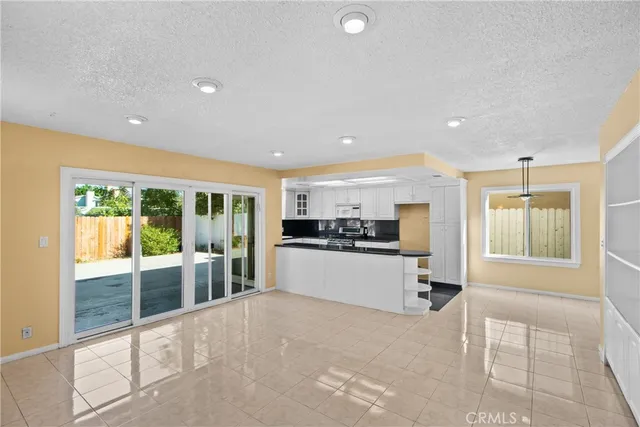 a kitchen with stainless steel appliances a refrigerator and a stove top oven