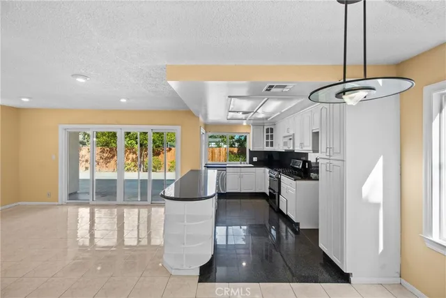 a living room with furniture a rug and a chandelier