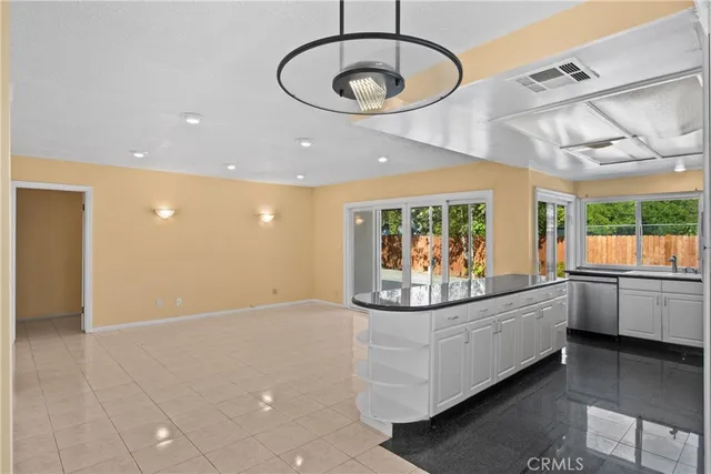 a view of a kitchen with furniture and chandelier