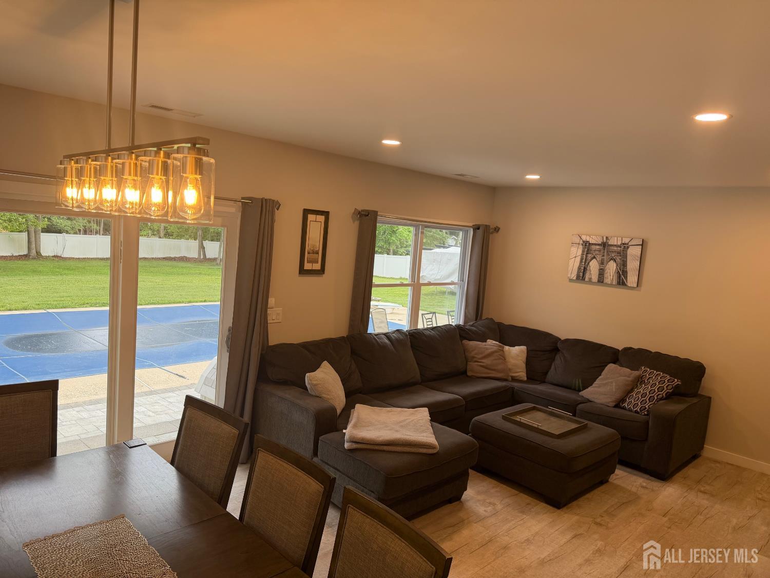 566 Ticetown Road Old Bridge, NJ 08857 - Photo 3 of 23 a living room with furniture and a chandelier