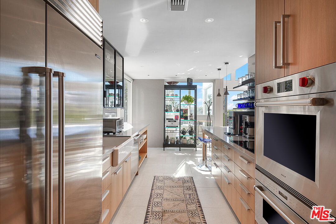 31201 Bailard Road Malibu, CA 90265 - Photo 15 of 56 a kitchen with stainless steel appliances a refrigerator and a sink