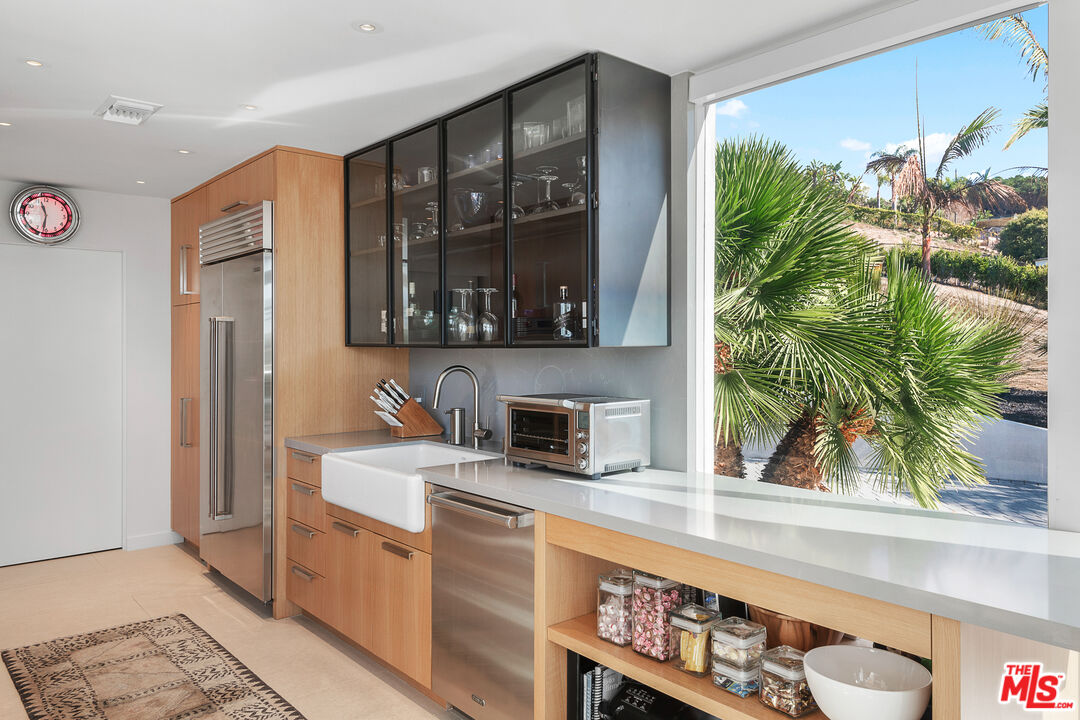 31201 Bailard Road Malibu, CA 90265 - Photo 17 of 56 a kitchen with a stove a sink and a microwave