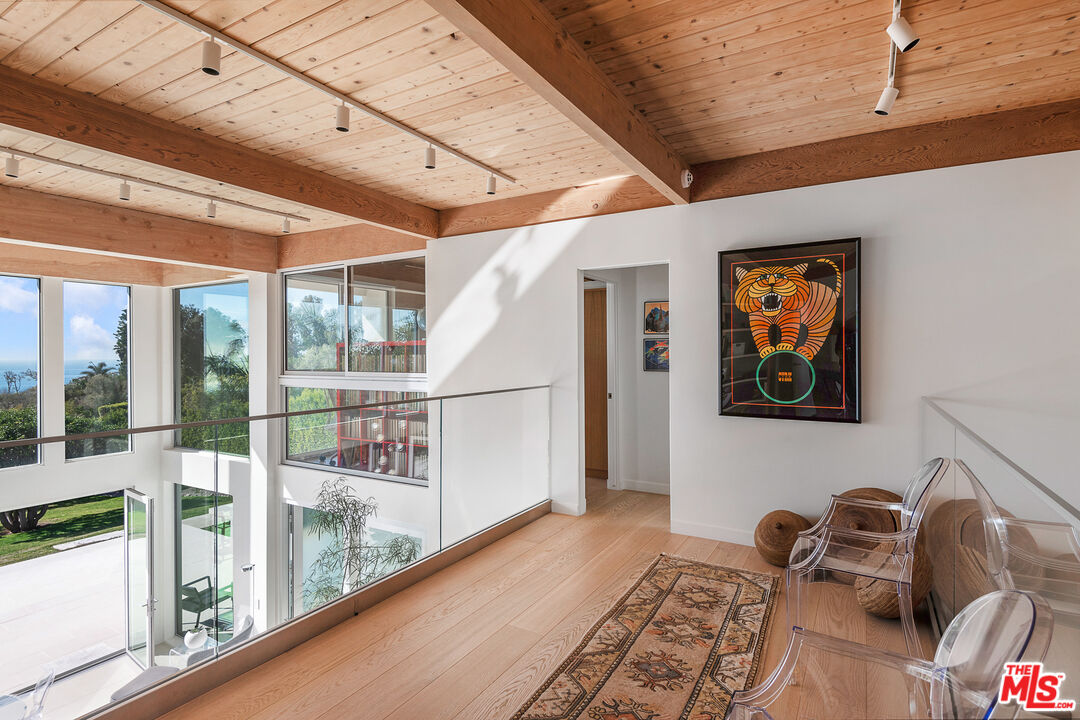 31201 Bailard Road Malibu, CA 90265 - Photo 35 of 56 a view of a hallway with couch and wooden floor