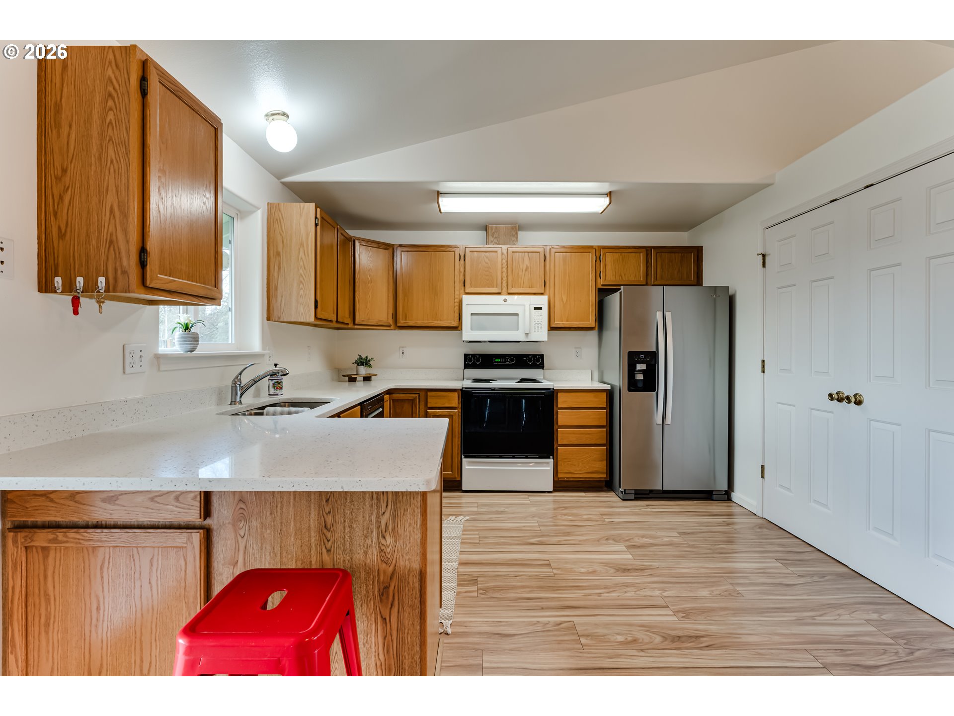3497 Douglas Drive Springfield, OR 97478 - Photo 11 of 38 a kitchen with stainless steel appliances granite countertop a refrigerator a sink dishwasher a stove with wooden cabinets