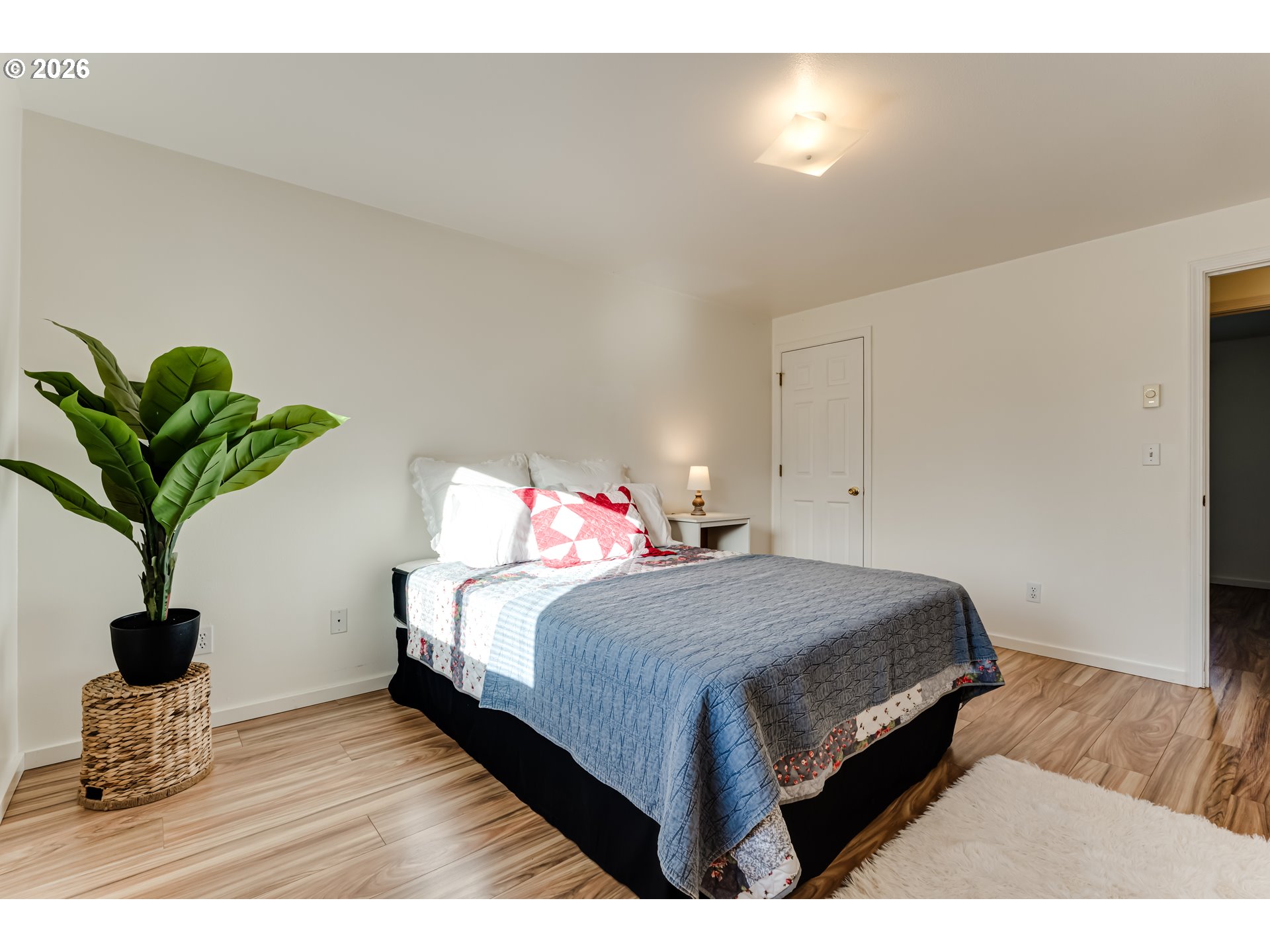 3497 Douglas Drive Springfield, OR 97478 - Photo 20 of 38 a bedroom with a bed potted plant with the wooden floor