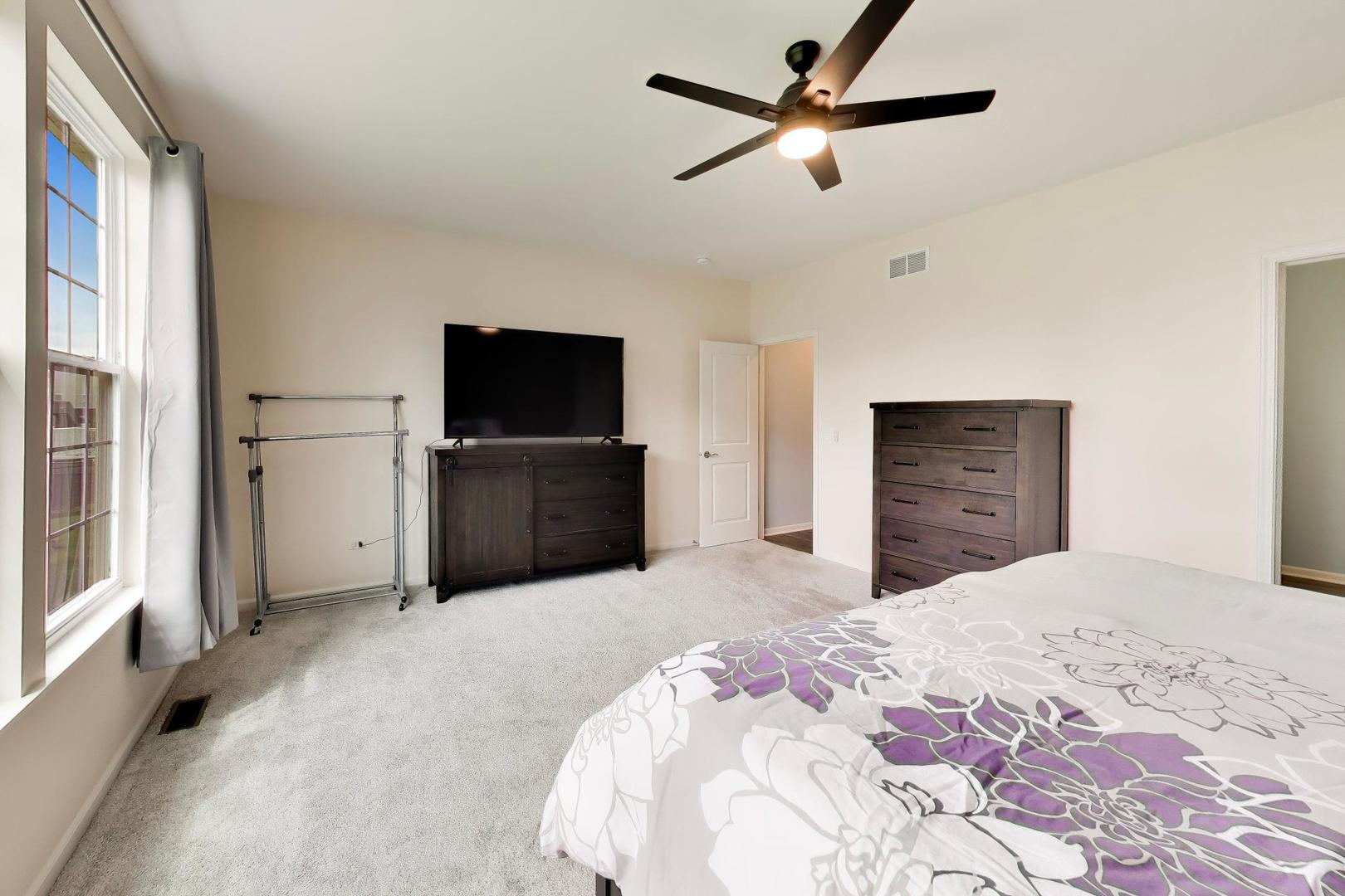 14831 Whitney Street Manhattan, IL 60442 - Photo 16 of 37 a bedroom with a bed and a flat screen tv