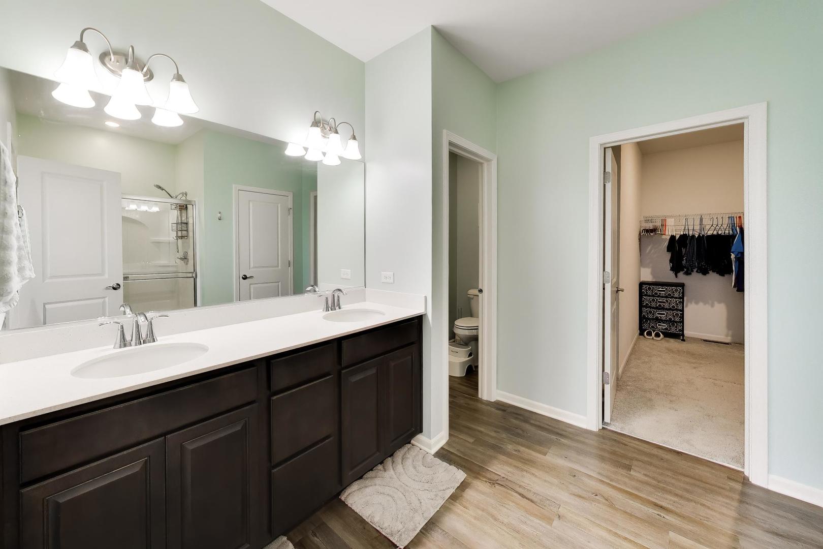 14831 Whitney Street Manhattan, IL 60442 - Photo 17 of 37 a bathroom with a sink double vanity and a mirror