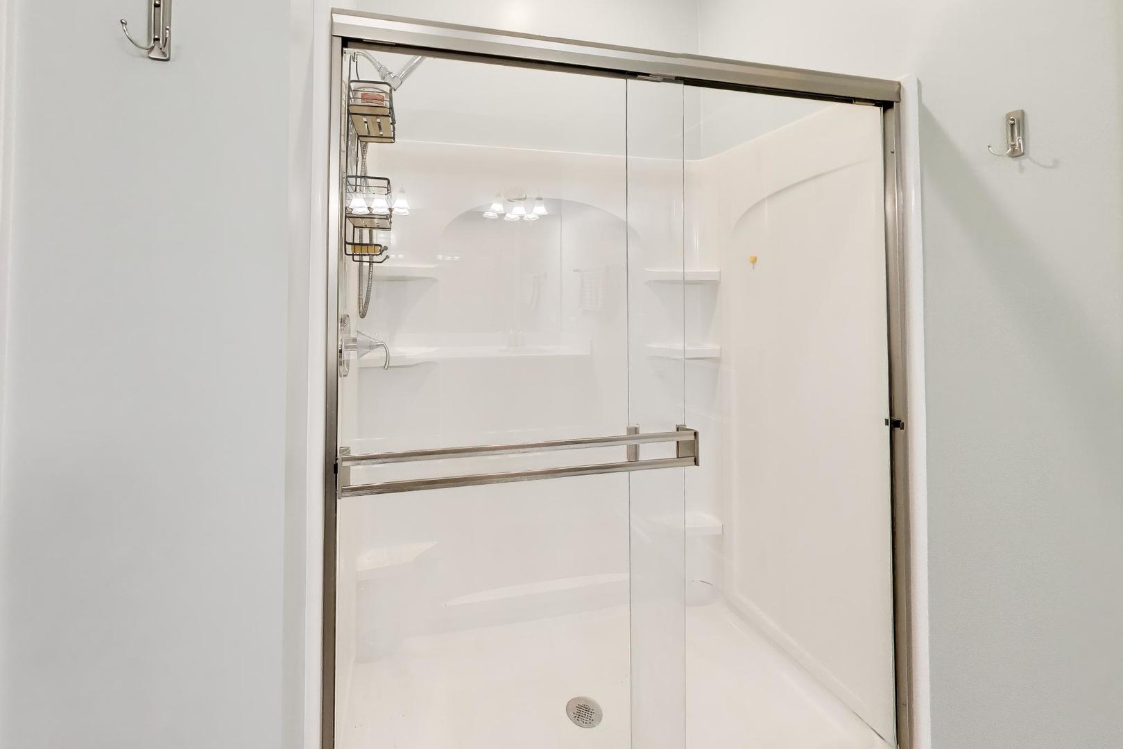 14831 Whitney Street Manhattan, IL 60442 - Photo 18 of 37 a bathroom with a glass shower door